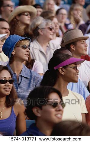 Group of spectators sitting in a stadium View Large Photo Image Stock Image - Group of spectators sitting in a stadium. Fotosearch
