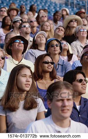 Group of spectators sitting in a stadium View Large Photo Image Stock Image - Group of spectators sitting in a stadium. Fotosearch