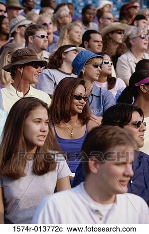 Group of spectators sitting in a stadium View Large Photo Image Stock Image - Group of spectators sitting in a stadium. Fotosearch