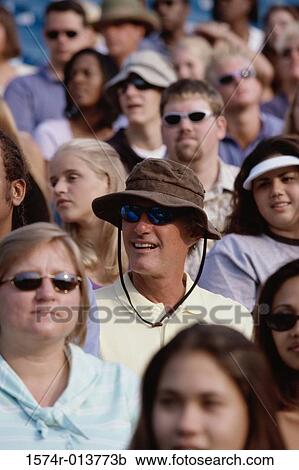 Group of spectators sitting in a stadium View Large Photo Image Stock Image - Group of spectators sitting in a stadium. Fotosearch