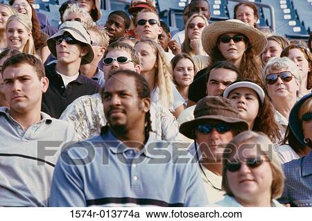 Group of spectators sitting in a stadium View Large Photo Image Stock Image - Group of spectators sitting in a stadium. Fotosearch