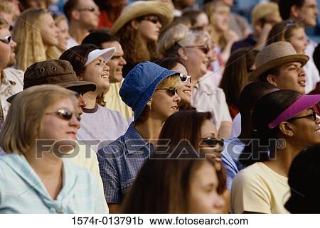 Stock Image - Group of spectators sitting in a stadium. Fotosearch