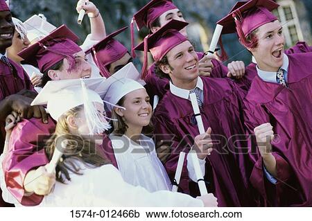 Stock Image - Group of teenage graduates celebrating. Fotosearch