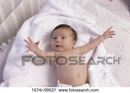 High angle view of a baby lying in a crib View Large Photo Image Stock Photo - High angle view of a baby lying in a crib. Fotosearch