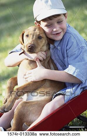 High angle view of a boy sitting in a wagon with his dog View Large Photo Image Stock Image - High angle view of a boy sitting in a wagon with his dog. Fotosearch