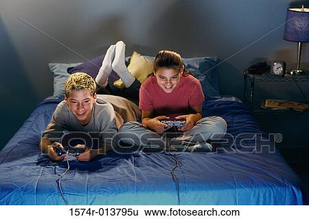 High angle view of a brother and sister playing video games View Large Photo Image Stock Photograph - High angle view of a brother and sister playing video games. Fotosearch