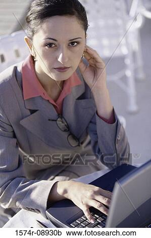 High angle view of a businesswoman sitting in front of a laptop View Large Photo Image Stock Image - High angle view of a businesswoman sitting in front of a laptop. Fotosearch