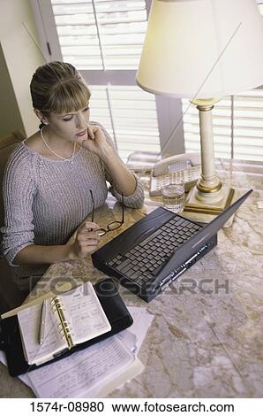 Stock Image - High angle view of a businesswoman working on a laptop. Fotosearch