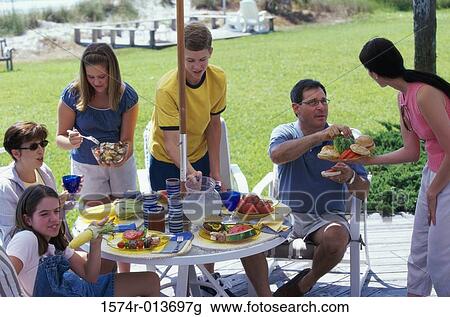 Stock Image - High angle view of a family eating. Fotosearch