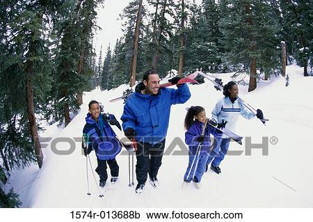 High angle view of a family walking in snow View Large Photo Image Stock Image - High angle view of a family walking in snow. Fotosearch