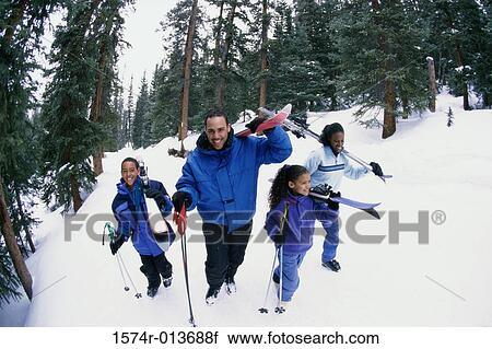 High angle view of a family walking in snow View Large Photo Image Stock Image - High angle view of a family walking in snow. Fotosearch