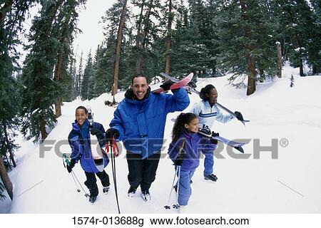 High angle view of a family walking in snow View Large Photo Image Stock Image - High angle view of a family walking in snow. Fotosearch
