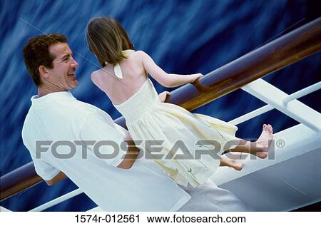 High angle view of a father standing with his daughter on the deck of a cruise ship View Large Photo Image Stock Image - High angle view of a father standing with his daughter on the deck of a cruise ship. Fotosearch