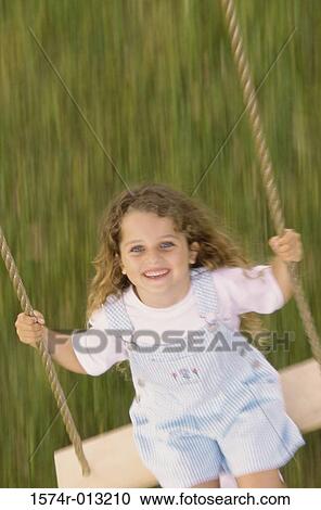 High angle view of a girl swinging on a swing View Large Photo Image Stock Image - High angle view of a girl swinging on a swing. Fotosearch