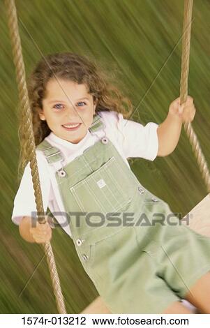 High angle view of a girl swinging on a swing View Large Photo Image Stock Image - High angle view of a girl swinging on a swing. Fotosearch
