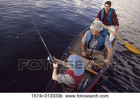 Stock Image - High angle view of a grandfather sitting with his son and grandson in a boat. Fotosearch