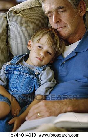 Stock Photo - High angle view of a grandfather sleeping with his grandson. Fotosearch