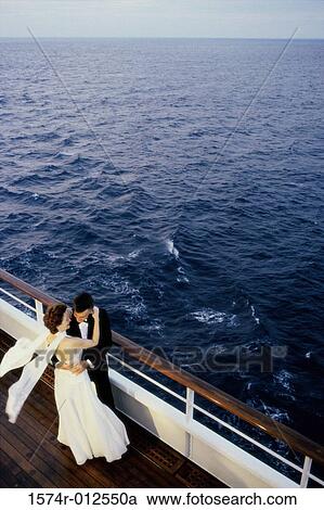 Stock Image - High angle view of a mature couple dancing on the deck of a cruise ship. Fotosearch