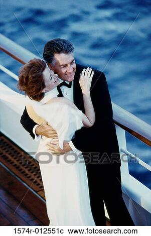 Stock Image - High angle view of a mature couple dancing on the deck of a cruise ship. Fotosearch