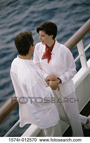 High angle view of a mid adult couple standing on the deck of a cruse ship View Large Photo Image Stock Image - High angle view of a mid adult couple standing on the deck of a cruse ship. Fotosearch