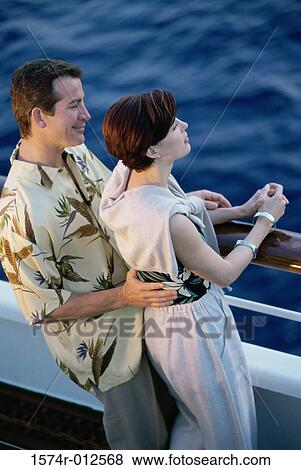 Stock Photo - High angle view of a mid adult couple standing on the deck of a cruise ship. Fotosearch