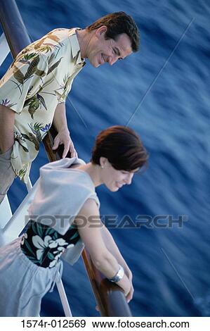 High angle view of a mid adult couple standing on the deck of a cruise ship View Large Photo Image Stock Photo - High angle view of a mid adult couple standing on the deck of a cruise ship. Fotosearch