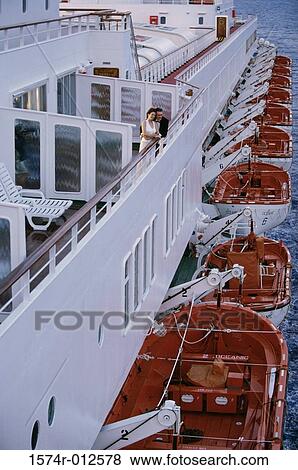 Stock Photo - High angle view of a mid adult couple standing on the deck of a cruise ship. Fotosearch