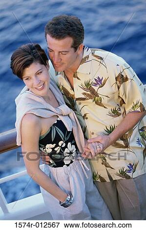 High angle view of a mid adult man holding hands with a mid adult woman View Large Photo Image Stock Photo - High angle view of a mid adult man holding hands with a mid adult woman. Fotosearch