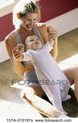 High angle view of a mother helping her son stand View Large Photo Image Stock Image - High angle view of a mother helping her son stand. Fotosearch
