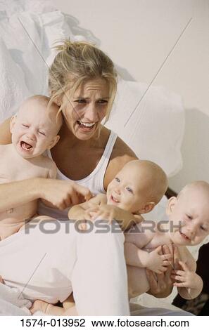 High angle view of a mother holding her three sons View Large Photo Image Stock Image - High angle view of a mother holding her three sons. Fotosearch