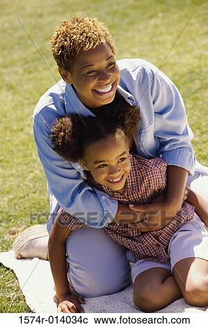 High angle view of a mother holding her daughter on a lawn View Large Photo Image Stock Image - High angle view of a mother holding her daughter on a lawn. Fotosearch