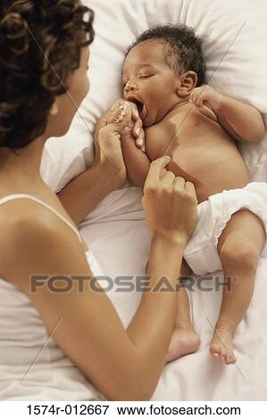High angle view of a mother playing with her son on the bed View Large Photo Image Stock Photo - High angle view of a mother playing with her son on the bed. Fotosearch