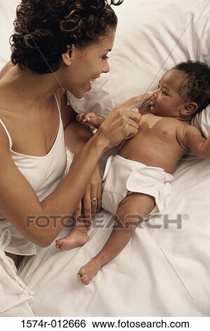 High angle view of a mother playing with her son on the bed View Large Photo Image Stock Photograph - High angle view of a mother playing with her son on the bed. Fotosearch
