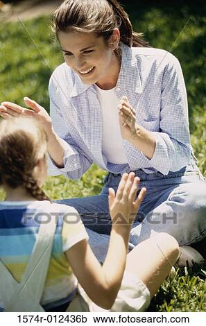 High angle view of a mother sitting with her daughter in a garden View Large Photo Image Stock Image - High angle view of a mother sitting with her daughter in a garden. Fotosearch