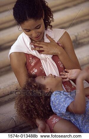 Stock Image - High angle view of a mother talking with her daughter. Fotosearch