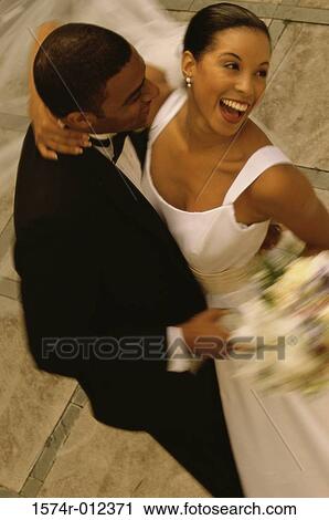 Stock Image - High angle view of a newlywed couple dancing. Fotosearch
