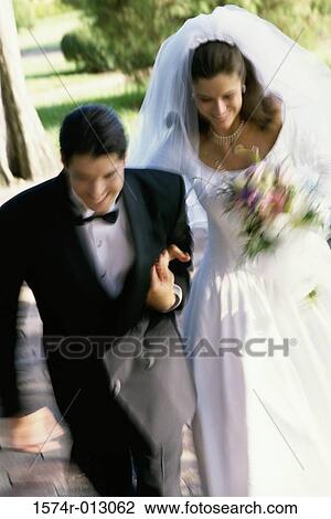 Stock Image - High angle view of a newlywed couple smiling. Fotosearch