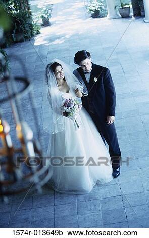 High angle view of a newlywed couple standing together View Large Photo Image Stock Image - High angle view of a newlywed couple standing together. Fotosearch
