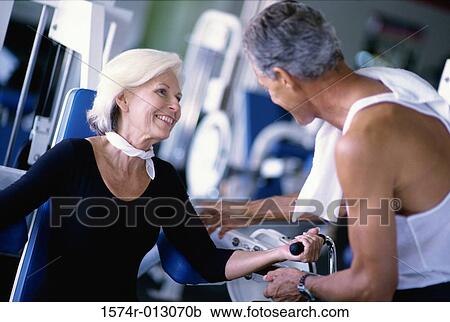 High angle view of a senior couple exercising in a gym View Large Photo Image Stock Image - High angle view of a senior couple exercising in a gym. Fotosearch