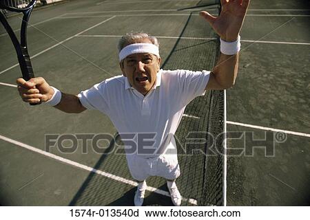 High angle view of a senior man looking angry on a tennis court View Large Photo Image Stock Image - High angle view of a senior man looking angry on a tennis court. Fotosearch