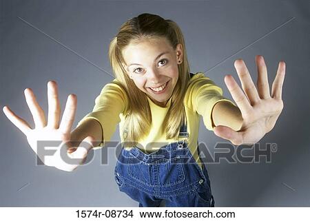 High angle view of a teenage girl with her arms stretched out View Large Photo Image Picture - High angle view of a teenage girl with her arms stretched out. Fotosearch
