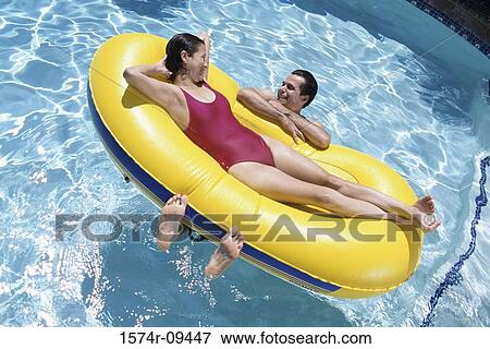 High angle view of a young couple lying on an inflatable raft View Large Photo Image Stock Photo - High angle view of a young couple lying on an inflatable raft. Fotosearch