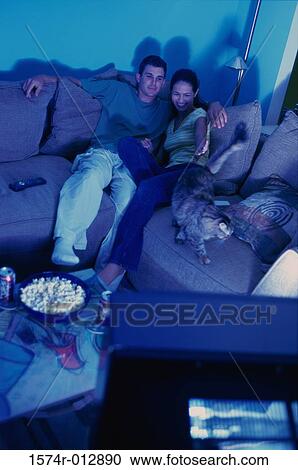 High angle view of a young couple watching television View Large Photo Image Stock Image - High angle view of a young couple watching television. Fotosearch