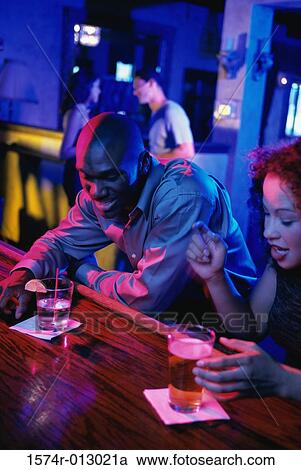 High angle view of a young couple sitting at a bar View Large Photo Image Stock Image - High angle view of a young couple sitting at a bar. Fotosearch
