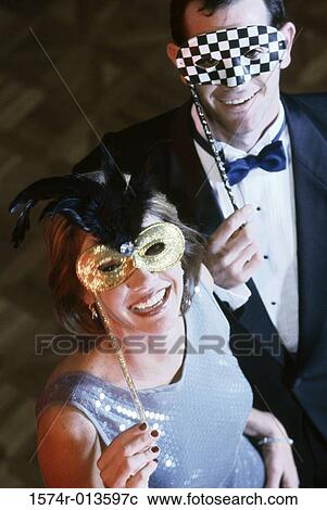 High angle view of a young couple wearing masks View Large Photo Image Stock Image - High angle view of a young couple wearing masks. Fotosearch