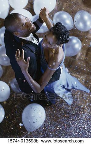 Stock Image - High angle view of a young couple dancing. Fotosearch