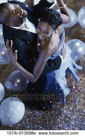 Stock Image - High angle view of a young couple dancing. Fotosearch