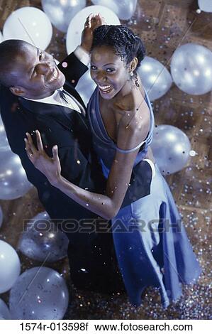 Stock Image - High angle view of a young couple dancing. Fotosearch