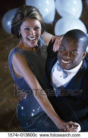 Stock Image - High angle view of a young couple dancing. Fotosearch