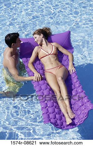High angle view of a young couple together in a swimming pool View Large Photo Image Stock Image - High angle view of a young couple together in a swimming pool. Fotosearch